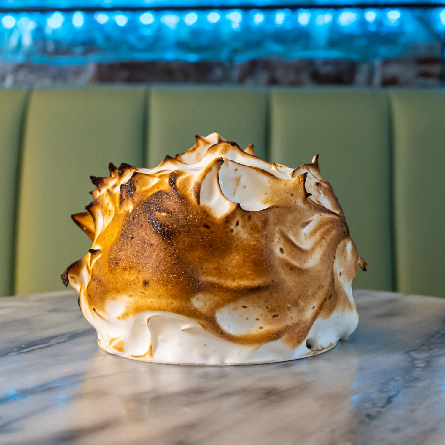 A torched baked Alaska dessert at Kakes