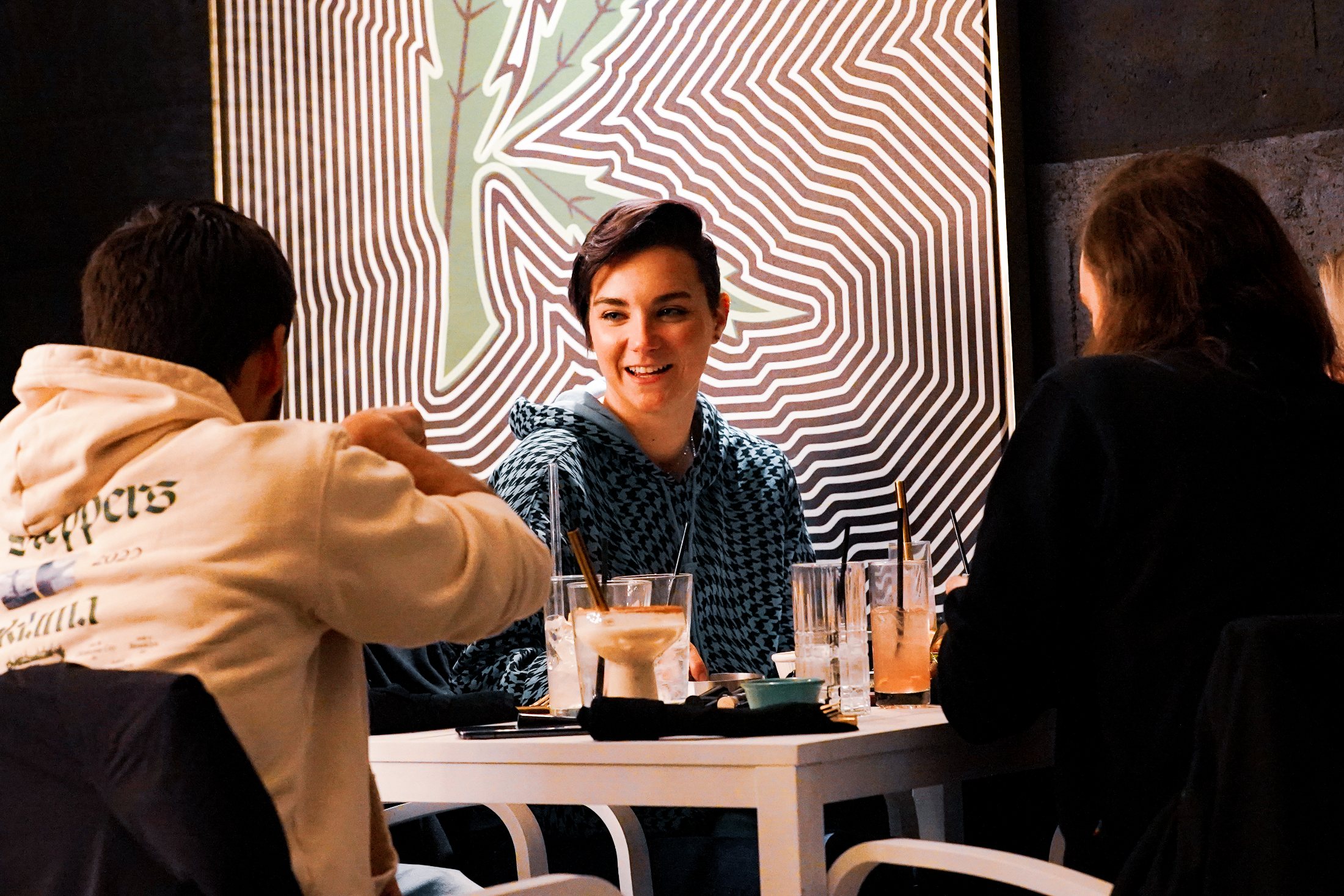 Friends celebrating with mocktails at a Kakes table